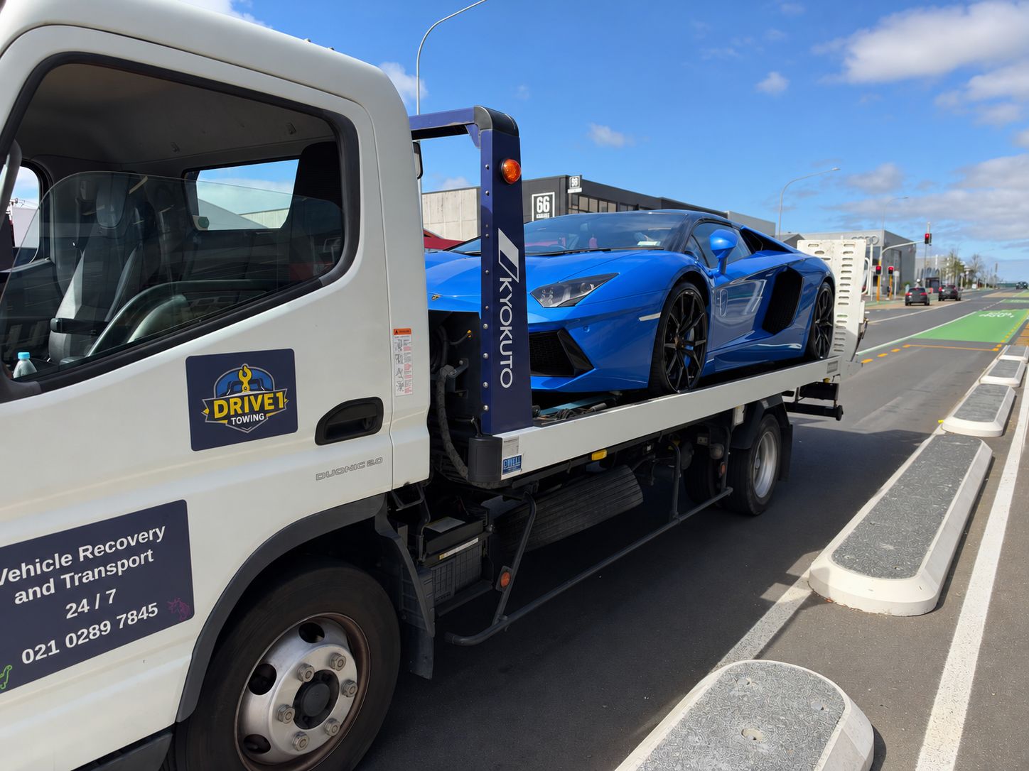 Lamborghini on a Drive1 flatbed in Auckland, with its body colour digitally changed to blue for privacy.